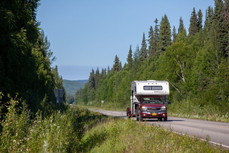 Cabover camper driving on Chena Hot Springs Road in summer