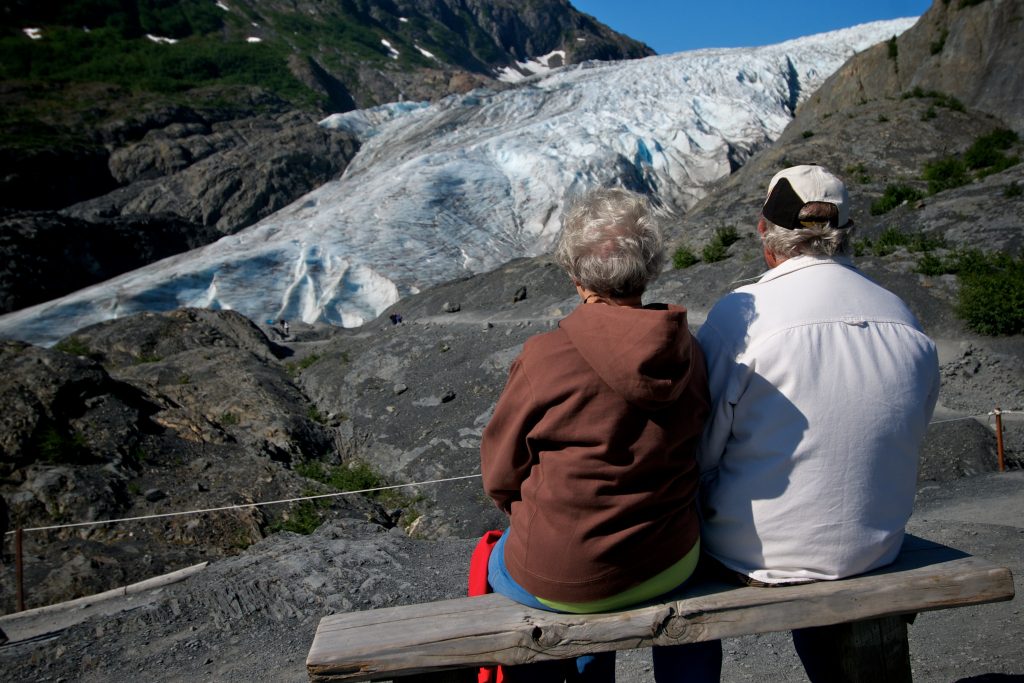 Exit Glacier hikers enjoy the view and sit on a bench
