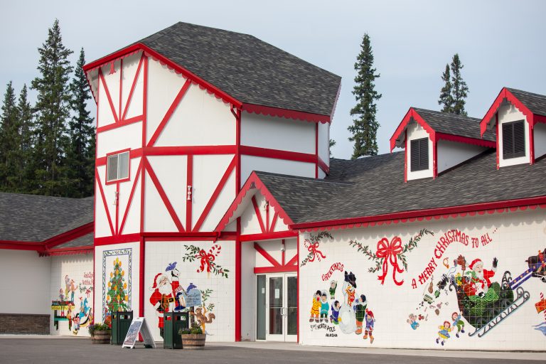 White building with red trim and Christmas decorations