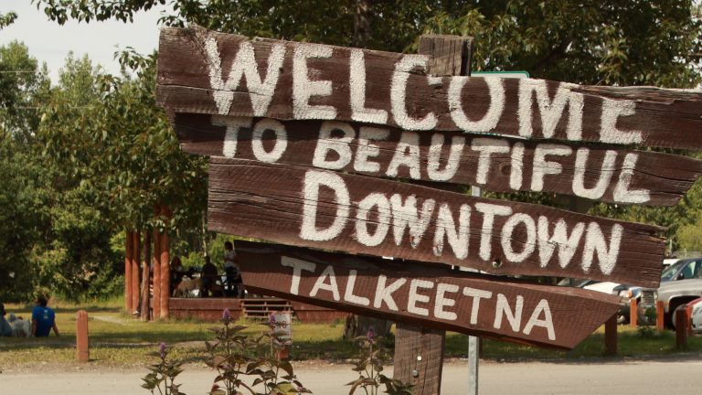 What to do in Talkeetna with One Day Wooden sign reads Welcome to beautiful downtown Talkeetna