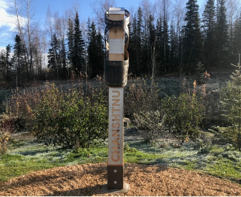 A wooden sign with metal plaque that reads Chanshtnu, one of the indigenous Dena'ina names being recognized around Anchorage
